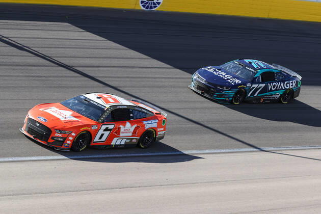 LAS VEGAS, NV - OCTOBER 16: Brad Keselowski ( 6 RFK Racing King s Hawaiian Ford) and Landon Cassill ( 77 Spire Motorsports Voyager: Crypto for All Chevrolet) drive into turn one during the NASCAR, Motorsport, USA Cup Series Playoff South Point 400, on October 16, 2022, at Las Vegas Motor Speedway in Las Vegas, NV.(Photo by Christopher Trim Icon Sportswire) AUTO: OCT 16 NASCAR Cup Series Playoff South Point 400 Icon221016007400
