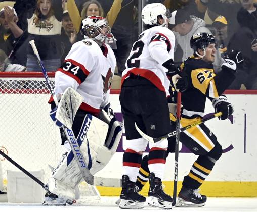 Pittsburgh Penguins right wing Rickard Rakell (67) skates pass Ottawa Senators goaltender Dylan Ferguson (34) as he celebrates his third period goal at PPG Paints Arena in Pittsburgh on Monday, March 20, 2023.  PIT2023032016 ARCHIExCARPENTER