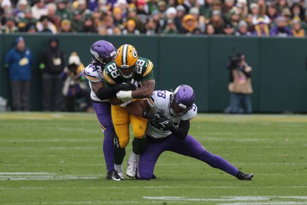 GREEN BAY, WI - OCTOBER 29: Green Bay Packers running back AJ Dillon (28) is tackled during a game between the Green Bay Packers and the Minnesota Vikings on October 29, 2023 at Lambeau Field, in Green Bay, WI. (Photo by Larry Radloff Icon Sportswire) NFL, American Football Herren, USA OCT 29 Vikings at Packers EDITORIAL USE ONLY Icon2310291984