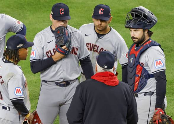 Cleveland Guardians pitcher Erik Sabrowski (C) receives a visit to the mound after giving up a run to the New York Yankees during the sixth inning of ALCS Game 2 at Yankee Stadium in New York, on Tuesday, October 15, 2024.  NYP20241015321 JOHNxANGELILLO