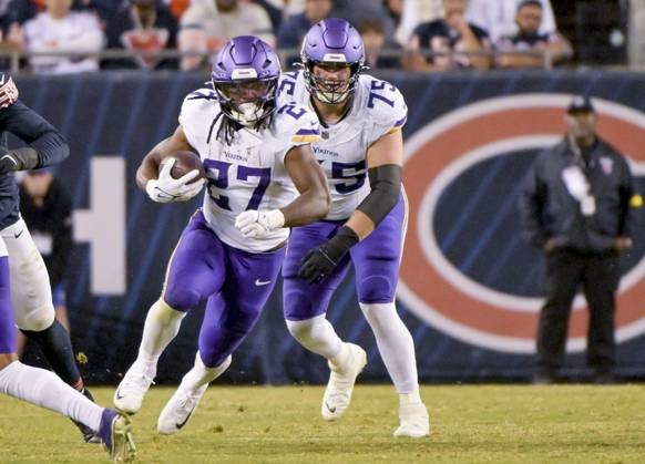Minnesota Vikings running back Jordan Mason (27) runs up the middle during the fourth quarter against the Chicago Bears at Soldier Field in Chicago on Monday, September 8, 2025. The Vikings defeated the Bears 27-24.  CHI20250908136 MARKxBLACK