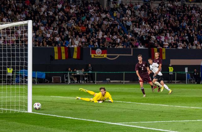 Soccer, Youth, Season 2025 26, U21, European Championship Qualification Group F 3 Matchday in Rostock, Germany Latvia, Nicolo Tresoldi 2 v r , U21, Germany scores the goal for 3 0 against goalkeeper Nikita Parfjonovs, 09 09 2025, Copyright: xMatthiasxKochx