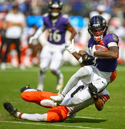 Baltimore Ravens wide receiver Zay Flowers (4) earns a first down after a catch over Cleveland Browns cornerback Greg Newsome II (0) during the fourth quarter of the Ravens home opener at M&T Bank Stadium in Baltimore, Maryland, on Sunday, September 14, 2025.  BAL20250914140 DAVIDxTULIS