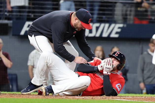 Cleveland Guardians manager Stephen Vogt comes to the aid of David Fry (6) after he fouled a pitch off his bat into his face in the sixth inning against the Detroit Tigers at Progressive Field in Cleveland, Ohio on Tuesday, September 23, 2025. Fry would leave the game. CLE20250923118 AARONxJOSEFCZYK