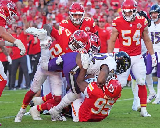 Baltimore Ravens running back Derrick Henry (22) gets tackled for a loss by Kansas City Chiefs defensive end Chris Jones (95) and Kansas City Chiefs defensive back Chamarri Conner (27) at Arrowhead Stadium in Kansas City, Missouri on Sunday, September 28, 2025. KCP2025092815 JONxROBICHAUD