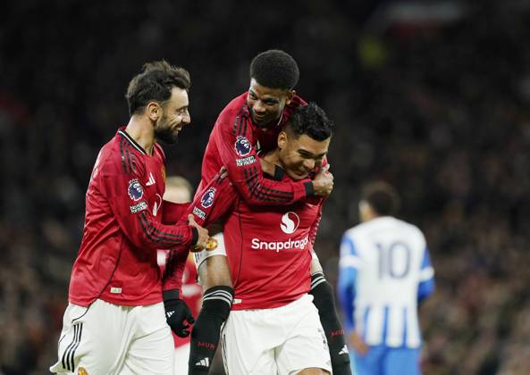 Manchester, England, 25th October 2025. Amad Diallo of Manchester United, ManU jumps up onto Casemiro of Manchester United as they celebrate after his shot was deflected into the goal by Yasin Ayari of Brighton during the Manchester United vs Brighton and Hove Albion Premier League match at Old Trafford, Manchester. Picture credit should read: Andrew Yates Sportimage EDITORIAL USE ONLY. No use with unauthorised audio, video, data, fixture lists, club league logos or live services. Online in-match use limited to 120 images, no video emulation. No use in betting, games or single club league player publications. SPI_037_AY_Man_Utd_Brighton SPI-4237-0036