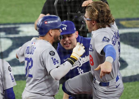 Los Angeles Dodgers Miguel Rojas (72) celebrates with Enrique Hernandez after hitting a solo home run in the ninth inning against the Toronto Blue Jays during Game Seven of the MLB, Baseball Herren, USA World Series at Rogers Centre in Toronto, Canada, on Saturday, November 1, 2025. TOR20251101868 AARONxJOSEFCZYK
