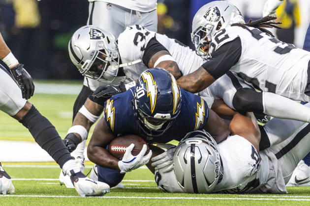 NFL, American Football Herren, USA 2025: Los Angeles Chargers 31:14 Las Vegas Raiders Los Angeles Chargers running back Kimani Vidal 30 is tackled by the Las Vegas Raiders during an NFL football game at SoFi Stadium, Sunday Nov. 30, 2025, in Inglewood, Calif. Los Angeles United States Copyright: xRingoxChiux xSOPAxImagesx 20251130RC.Chargers009