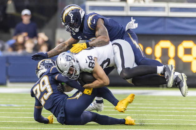 NFL, American Football Herren, USA 2025: Los Angeles Chargers 31:14 Las Vegas Raiders Las Vegas Raiders wide receiver Brock Bowers 89 is tackled by Los Angeles Chargers cornerback Tarheeb Still 29 and linebacker Denzel Perryman 6 during an NFL football game at SoFi Stadium, Sunday Nov. 30, 2025, in Inglewood, Calif. Los Angeles United States Copyright: xRingoxChiux xSOPAxImagesx 20251130RC.Chargers016