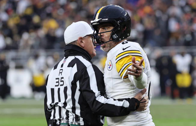Pittsburgh Steelers quarterback Aaron Rogers (8) is held back by referee John Hussey (35) as he argues with the Cleveland Browns sideline after an incomplete pass on fourth down during the fourth quarter at Huntington Bank Field in Cleveland, Ohio on Sunday December 28, 2025.  CLE20251228115 AARONxJOSEFCZYK