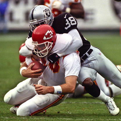 November 28, 1999 - Oakland, California, U.S - Oakland Raiders vs. Kansas City Chiefs at Oakland Alameda County Coliseum Sunday, November 29, 1999. Chiefs beat Raiders 37-34. Oakland Raiders defensive back Marquis Walker (38) sacks Kansas City Chiefs quarterback Elvis Grbac Copyright: xAlxGolubx