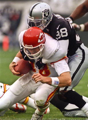November 28, 1999 - Oakland, California, U.S - Oakland Raiders vs. Kansas City Chiefs at Oakland Alameda County Coliseum Sunday, November 29, 1999. Chiefs beat Raiders 37-34. Oakland Raiders defensive back Marquis Walker (38) sacks Kansas City Chiefs quarterback Elvis Grbac Copyright: xAlxGolubx
