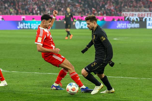 in duel, action, with Alexandar Pavlovic 45 FC Bayern Muenchen , Elvis Rexhbecaj 8 FC Augsburg , FC Bayern Muenchen vs FC Augsburg, Soccer, 1 Bundesliga, 19 Matchday, 24 01 2026 DFB regulations prohibit any use of photographs as image sequences and or quasi video Muenchen Bayern Germany Copyright: xkolbert-press ChristianxKolbertx