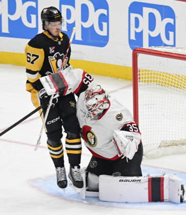 Pittsburgh Penguins right wing Rickard Rakell (67) receives a goalie Interference penalty as he collides with Ottawa Senators goaltender Linus Ullmark (35) during the first period at PPG Paints Arena in Pittsburgh on Monday, February 2, 2026.  PIT2026020206 ARCHIExCARPENTER