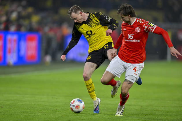 from left in duel Maximilian Beier Dortmund 14 Stefan Posch Mainz 4 13 02 2026 Soccer Borussia Dortmund vs 1 FSV Mainz 05, Signal Iduna Park, Dortmund, DFB DFL REGULATIONS PROHIBIT ANY USE OF PHOTOGRAPHS AS IMAGE SEQUENCES AND OR QUASI VIDEO Copyright: xpepphotox xHorstxMauelshagenx pep00321, pep_20260213_hm_279370