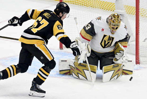 Pittsburgh Penguins right wing Rickard Rakell (67) chases the rebound off of Vegas Golden Knights goaltender Adin Hill (33) during the first period at PPG Paints Arena in Pittsburgh on Sunday, March 1, 2026.  PIT2026030105 ARCHIExCARPENTER