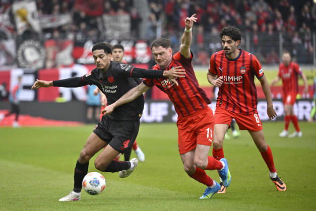 One-on-one, action Budu Zivzivadze Siwsiwadse 1 FC Heidenheim 1846 FCH 11 vs Jarell Quansah Bayer 04 Leverkusen 04 Eren Dinkci 1 FC Heidenheim 1846 FCH 08 1 FC Heidenheim 1846 FCH vs Bayer 04 Leverkusen B04 21 03 2026 DFL REGULATIONS PROHIBIT ANY USE OF PHOTOGRAPHS AS IMAGE SEQUENCES AND OR QUASI VIDEO 1 FC Heidenheim 1846 FCH vs Bayer 04 Leverkusen