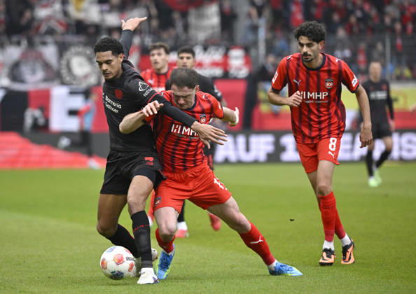 One-on-one, action Budu Zivzivadze Siwsiwadse 1 FC Heidenheim 1846 FCH 11 vs Jarell Quansah Bayer 04 Leverkusen 04 Eren Dinkci 1 FC Heidenheim 1846 FCH 08 1 FC Heidenheim 1846 FCH vs Bayer 04 Leverkusen B04 21 03 2026 DFL REGULATIONS PROHIBIT ANY USE OF PHOTOGRAPHS AS IMAGE SEQUENCES AND OR QUASI VIDEO 1 FC Heidenheim 1846 FCH vs Bayer 04 Leverkusen