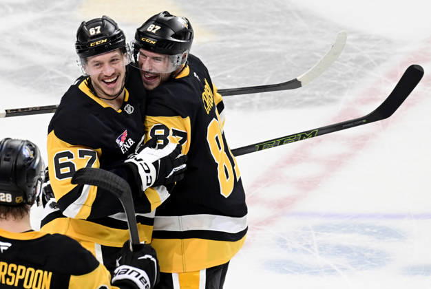 Pittsburgh Penguins right wing Rickard Rakell (67) celebrates his the overtime penalty shot goal with Pittsburgh Penguins center Sidney Crosby (87) following the Penguins 5-4 win against the Winnipeg Jets at PPG Paints Arena in Pittsburgh on Saturday, March 21, 2026.  PIT2026032115 ARCHIExCARPENTER