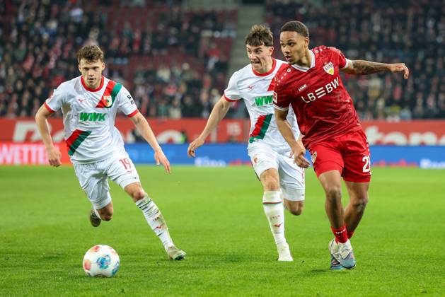 in duel, action, with Robin Fellhauer 19 FC Augsburg , Cedric Zesiger 16 FC Augsbburg , Nikolas Nartey 28 VfB Stuttgart , FC Augsburg vs VfB Stuttgart, Football, 1 Bundesliga, 27 Matchday, 22 03 2026 DFB regulations prohibit any use of photographs as image sequences and or quasi video Augsburg Bayern Germany Copyright: xkolbert-press ChristianxKolbertx