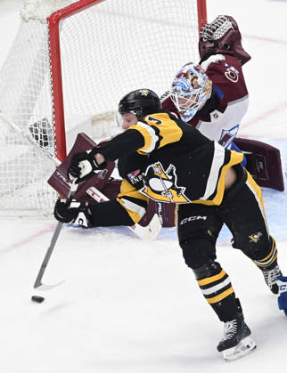 Pittsburgh Penguins right wing Rickard Rakell (67) attempts a backhanded shot on Colorado Avalanche goaltender Scott Wedgewood (41) during the second period at PPG Paints Arena in Pittsburgh on Tuesday, March 24, 2026.  PIT2026032412 ARCHIExCARPENTER