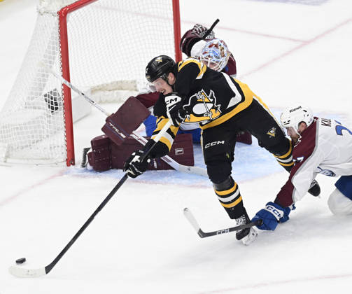 Pittsburgh Penguins right wing Rickard Rakell (67) attempts a backhanded shot on Colorado Avalanche goaltender Scott Wedgewood (41) during the second period at PPG Paints Arena in Pittsburgh on Tuesday, March 24, 2026.  PIT2026032413 ARCHIExCARPENTER