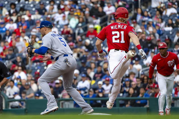 Los Angeles Dodgers first baseman Freddie Freeman (5) tags out Washington Nationals center fielder Joey Wiemer (21) at first base in the bottom of the fifth inning during a game at Nationals Park in Washington, DC on Sunday, April 5, 2026. WAP20260405340 BONNIExCASH