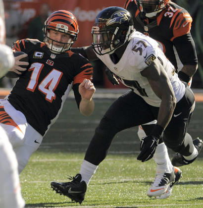 Oct. 26, 2014 - Cincinnati, OH, USA - Cincinnati Bengals quarterback Andy Dalton (14) goes into a slide in front of Baltimore Ravens inside linebacker C.J. Mosley (57) in the fourth quarter Sunday, Oct. 26, 2014 at Paul Brown Stadium in Cincinnati, Ohio. The Ravens fell to the Bengals 27-24. Copyright: xKarlxMertonxFerronx