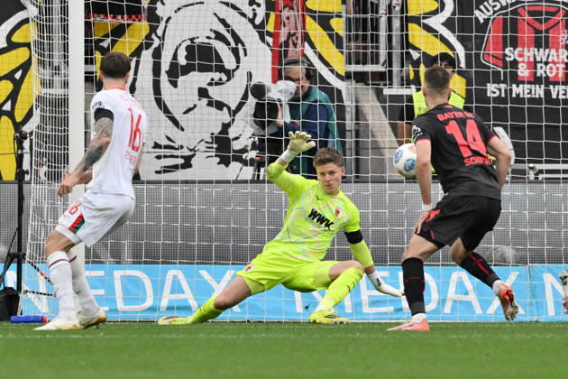 Goalkeeper Finn Dahmen FC Augsburg in action, right Patrik Schick Bayer 04 Leverkusen 18 04 2026, Soccer 1 Bundesliga, Season 2025 2026, 30 Matchday, Bayer 04 Leverkusen FC Augsburg 1 2 DFL regulations prohibit any use of photographs as image sequences and or quasi video Leverkusen BayArena Nordrhein Westfalen Germany Team2
