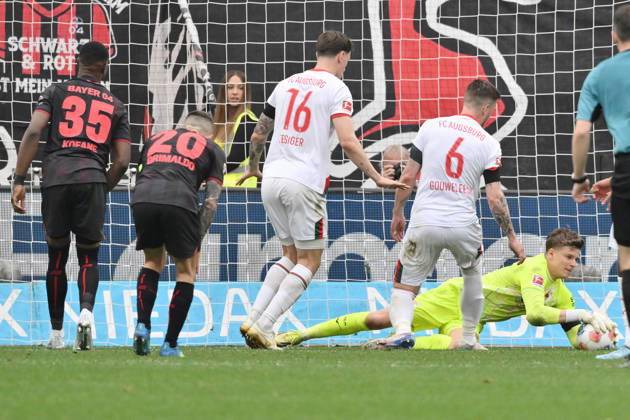 Goalkeeper Finn Dahmen FC Augsburg in action, left Jeffrey Gouweleeuw FC Augsburg , Cedric Zesiger FC Augsburg , Alejandro Grimaldo Bayer 04 Leverkusen , Christian Kofane Bayer 04 Leverkusen 18 04 2026, Soccer 1 Bundesliga, Season 2025 2026, Matchday 30, Bayer 04 Leverkusen FC Augsburg 1 2 DFL regulations prohibit any use of photographs as image sequences and or quasi video Leverkusen BayArena Nordrhein Westfalen Germany Team2
