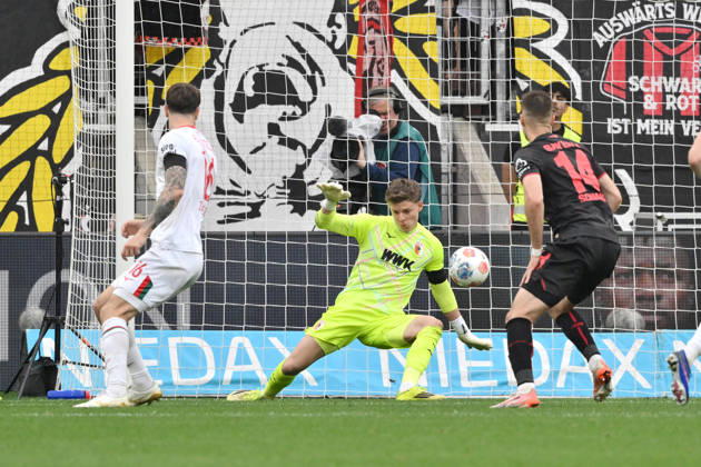 Goalkeeper Finn Dahmen FC Augsburg in action, right Patrik Schick Bayer 04 Leverkusen 18 04 2026, Soccer 1 Bundesliga, Season 2025 2026, 30 Matchday, Bayer 04 Leverkusen FC Augsburg 1 2 DFL regulations prohibit any use of photographs as image sequences and or quasi video Leverkusen BayArena Nordrhein Westfalen Germany Team2