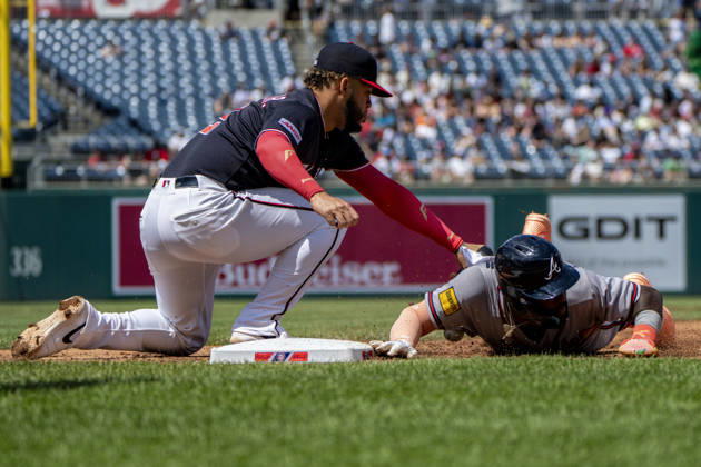 Atlanta Braves center fielder Michael Harris (23) slides into first base as Washington Nationals first baseman Luis Garcia Jr. (2) tags during the top of the fourth inning during a game at Nationals Park in Washington, DC on Thursday, April 23, 2026.  WAP20260423318 BONNIExCASH