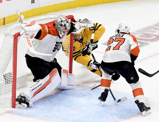 Pittsburgh Penguins right wing Rickard Rakell (67) watches as Pittsburgh Penguins defenseman Kris Letang shot finds the goal behind the skate of Philadelphia Flyers goaltender Dan Vladar (80) during the second period of the Penguins 3-2 win in the opening round of the Eastern Conference playoffs at PPG Paints Arena in Pittsburgh on Monday, April 27, 2026.  PIT2026042714 ARCHIExCARPENTER