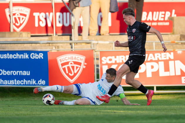 Soccer Mens Regionalliga Bayern Season 2025 2026 33 Matchday 08 05 2026 TSV Buchbach Viktoria Aschaffenburg SMR Arena Benjamin Baier L of SV Viktoria Aschaffenburg in a duel with Tobias Stoßberger R of TSV Buchbach Buchbach SMR Arena Bavaria Germany