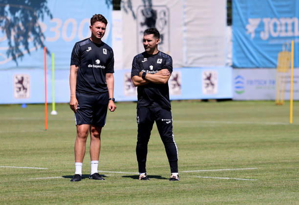 Soccer, Mens, Bavarian Regional League, 2026–2027 Season, TSV 1860 Munich, Training, Grünwalder Strasse 114 Vincent Saller, Assistant Coach of TSV 1860 Munich (left), with Alper Kayabunar, Head Coach of TSV 1860 Munich (right), in conversation on the training field,detected_source_language