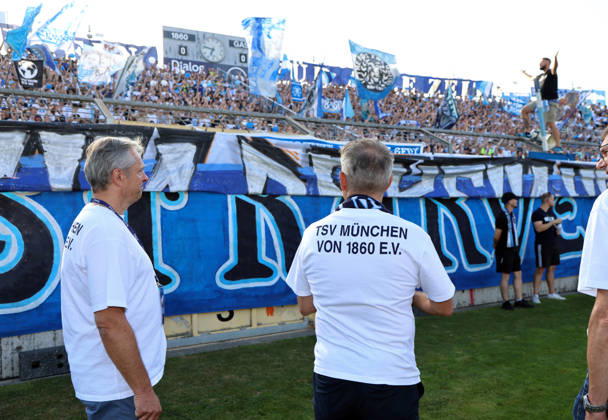 Soccer, Men s, Bavarian Regional League, 2026–2027 Season, TSV 1860 Munich vs. FC Augsburg II, Grünwalder Stadium: Here, Thomas Probst, Managing Director of TSV München von 1860 Spielbetriebs GmbH (left), stands with Gernot Mang, President of TSV 1860 Munich (right), after a job well done, in front of the Ultras, fans of TSV 1860 Munich, before the game