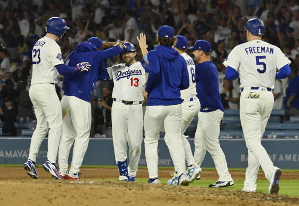 Los Angeles Dodgers Max Muncy (13) celebrates with teammates after hitting a walk-off RBI single in the tenth inning against the Kansas City Royals at Dodger Stadium in Los Angeles on Tuesday, August 11, 2026.  LAP2026081101 JIMxRUYMEN