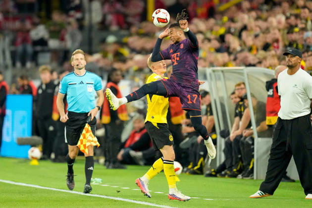 Daniel Svensson of Borussia Dortmund and Michael Olise of FC Bayern Munich battle for the ball during the Franz Beckenbauer Super Cup match between Borussia Dortmund and FC Bayern Munich at Signal Iduna Park on August 22, 2026, in Dortmund, Germany. Photo by Alex Gottschalk, DeFodi Images