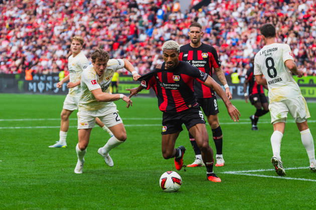 Tim Skarke of 1. FC Union Berlin (No. 21) battles Loic Bade of Bayer 04 Leverkusen (No. 05) for the ball in the penalty area; they’re pulling on each other’s jerseys, Robert Andrich of Bayer 04 Leverkusen, No. 08, watches; Bayer 04 Leverkusen vs. 1 FC Union Berlin, soccer, Bundesliga 1, Matchday 2, 2026–27 season, May 9, 2026, DFL regulations prohibit any use of photographs as image sequences and or quasi-video, Bayer 04 Leverkusen vs. 1 FC Union Berlin, soccer, Bundesliga 1, Matchday 2, 2026–27 season, May 9, 2026, Leverkusen Copyright: xEibner-Pressefoto LukasxBaldygax EP_LBA