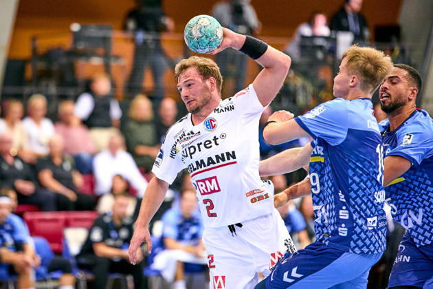 Frieder Bandlow 2, HC Erlangen, in a one-on-one with Linus Schmid 19, TVB 1898 Stuttgart, and Philipp Ahouansou 5, TVB 1898 Stuttgart September 24, 2026 Handball DHB Cup 2026–2027 Season, Round 2: TVB 1898 Stuttgart vs. HC Erlangen, Nuremberg Metropolitan Region, HCE PeKo xpexkox