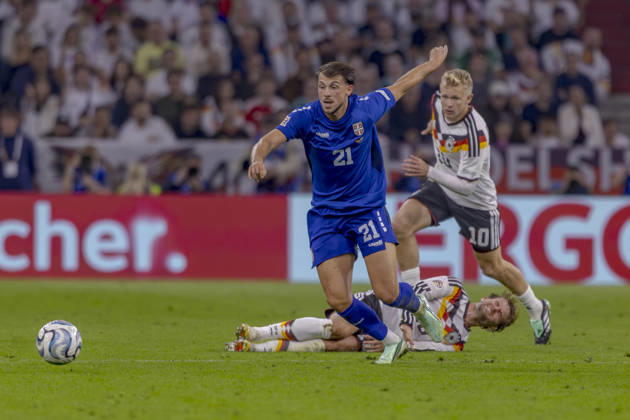 Munich, Germany, October 1, 2026 UEFA Nations League 2026–2027 League Phase Group A2 Match 3 Germany vs. Serbia Pictured from left in a tackle: Lazar Samardzic (SRB), Maximilian Mittelstädt (GER), and Jonathan Burkardt (GER). DFB and DFL regulations prohibit any use of photographs as image sequences and or quasi-video. Allianz Arena, Bayern Copyright: xFotostandx xSchäferx