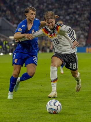 Munich, Germany October 1, 2026 UEFA Nations League 2026–2027 League Phase Group A2 Match 3 Germany vs. Serbia Pictured from left: Lazar Samardzic (SRB) and Maximilian Mittelstädt (GER) in a tackle. DFB and DFL regulations prohibit any use of photographs as image sequences or or quasi-video. Allianz Arena, Bayern Copyright: xFotostandx xSchäferx