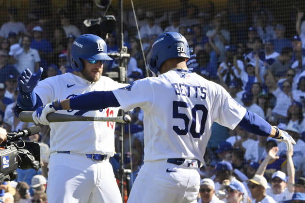 Los Angeles Dodgers Max Muncy celebrates with Mookie Betts after hitting a solo home run in the sixth inning against the Atlanta Braves in game one of the National League Division Series at Dodger Stadium on Saturday, October 3, 2026 in Los Angeles, California.  LAP202610033052 JIMxRUYMEN