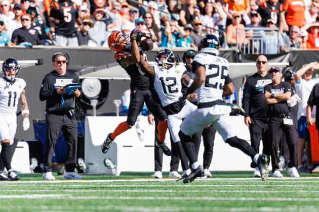 Oct 4, 2026; Cincinnati, OH, USA; Cincinnati Bengals wide receiver Mitch Tinsley (82) and Jacksonville Jaguars defensive back Travis Hunter (12) battle for the ball during NFL, American Football Herren, USA game action at Paycor Stadium. Mandatory Credit: -Cal Media - ZUMAc04_ 20261004_zma_c04_580 Copyright: xJohnxMersitsx