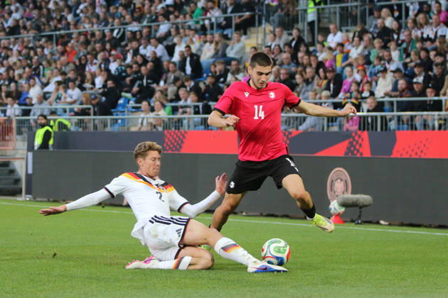 October 6, 2026 Men s Soccer 2026–2027 UEFA U-21 European Championship Qualifiers Matchday 12 Germany vs. Georgia SchücoArena, Bielefeld Elias Baum (Germany, No. 2, in white) slides in to tackle Aleko Basiladze (Georgia, 14, red card from Bielefeld, North Rhine-Westphalia, Germany