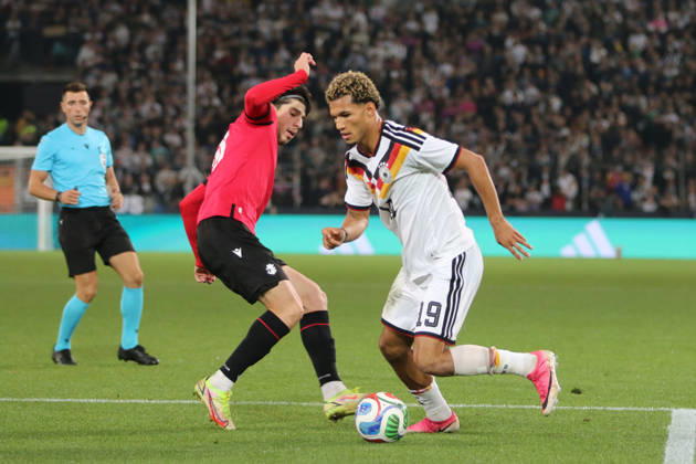 October 6, 2026 Men s Soccer 2026–2027 UEFA U-21 European Championship Qualifiers Matchday 12 Germany vs. Georgia SchücoArena, Bielefeld Paris Brunner, Germany, 19, in white, passes Nikoloz Dadiani of Georgia, 10, in red, in Bielefeld, North Rhine-Westphalia, Germany