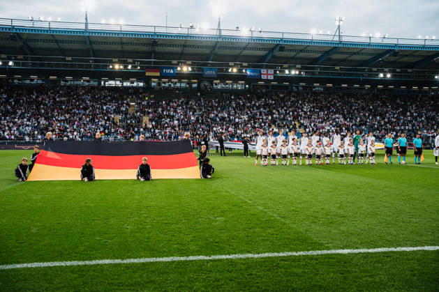 U21 European Championship Qualifier: Germany vs. Georgia, October 6, 2026; Germany during the national anthem: Paris Brunner (Germany), 19; Noah Darvich (Germany), 17; Aljoscha Kemlein (Germany), 16; Dženan Pejcinovic, Germany, 11, Nnamdi Collins, Germany, 20, Noel Aseko, Germany, 8, Joshua Quarshie, Germany, 5, Lukas Ullrich, Germany, 3, Elias Baum, Germany, 2, Mio Backhaus, Germany, 1, Nicolò Tresoldi Germany, 9, next to it: Germany on the ground playing soccer, U-21 European Championship Qualifiers, Matchday 10: Germany vs. Georgia on October 6, 2026, Bielefeld DFB REGULATIONS PROHIBIT ANY USE OF PHOTOGRAPHS AS IMAGE SEQUENCES AND OR QUASI-VIDEO Copyright: xBEAUTIFULxSPORTS Tonhäuserx