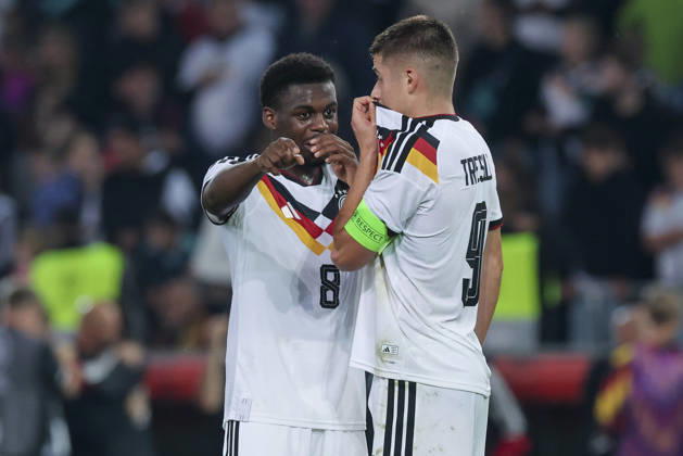 Noel Aseko (Germany) and Nicolo Tresoldi (Germany) talk during the UEFA Under-21 EURO qualifier between Germany U21 and Georgia U21 at Almstadion on October 6, 2026, in Bielefeld, Germany. Photo by Marco Steinbrenner, DeFodi Images