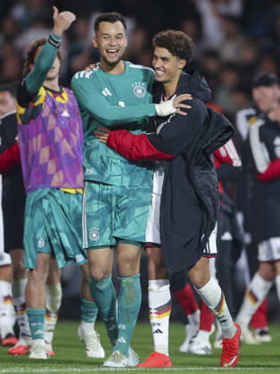 Goalkeepers Mio Backhaus (Germany) and Noah Darvich (Germany) cheer during the UEFA Under-21 EURO qualifier between Germany U21 and Georgia U21 at Almstadion on October 6, 2026, in Bielefeld, Germany. Photo by Marco Steinbrenner, DeFodi Images