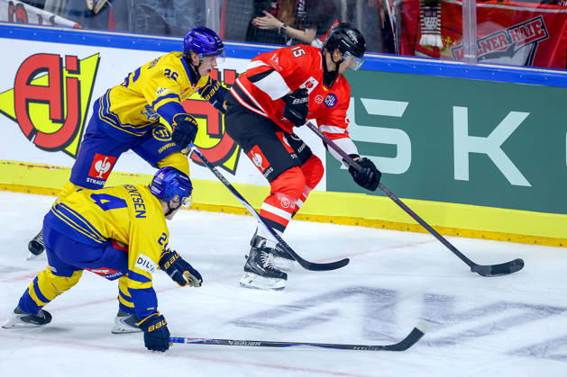October 7, 2026, Ice Hockey, CHL, Kölner Haie vs. Blue Fox Herning, Champions Hockey League 2026–27, Matchday 5, 2026–27 Season, Lanxess Arena, Cologne: Louis Marc Aubry of the Kölner Haie (No. 15) battles Valdemar Bilgrav (No. 26) and Lasse Baerentsen (No. 24) of Blue Fox Herning; North Rhine-Westphalia, Germany